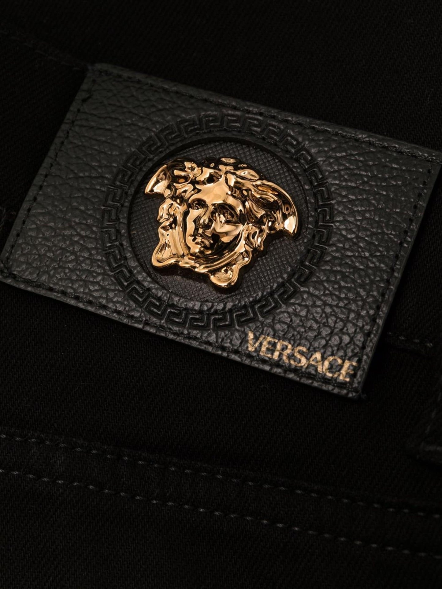 medusa plaque bootcut jeans by versace - bottegalusso: premier destination for modern luxury menswear